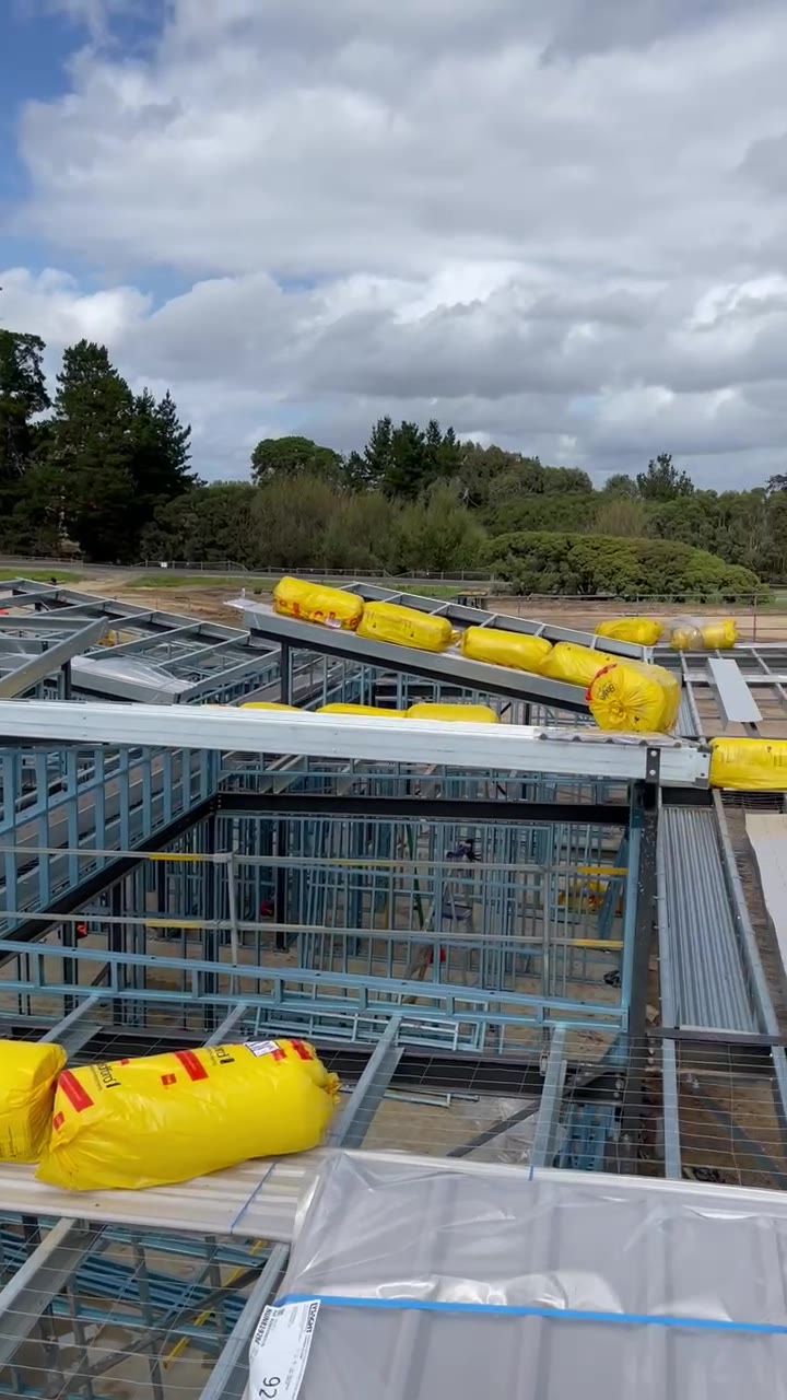 Wide view of the Browns Road Sports Centre structure during roofing