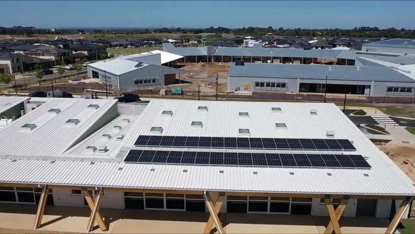 Overhead drone view of white Klip-Lok roofs and skylights