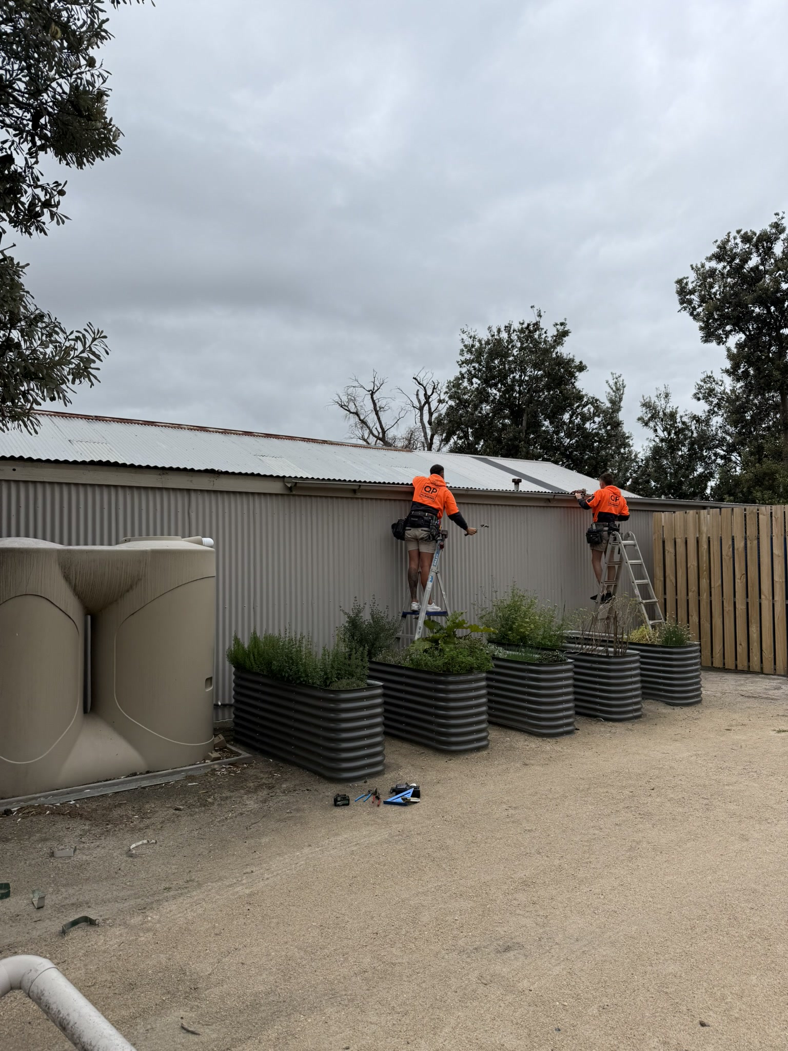 QP crew installing flashings and downpipes at Woodleigh College